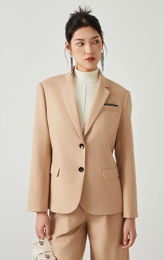 Woman in Desert Sand blazer looking to the side, highlighting chest pocket with rhinestone trim. From Borcelleclothes.