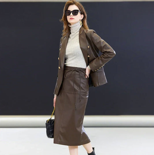 Women’s double-breasted leather blazer in Dark Rum — a structured silhouette with peaked lapels, embossed metallic buttons, and a rich, warm tone that evokes timeless presence. From Borcelleclothes.