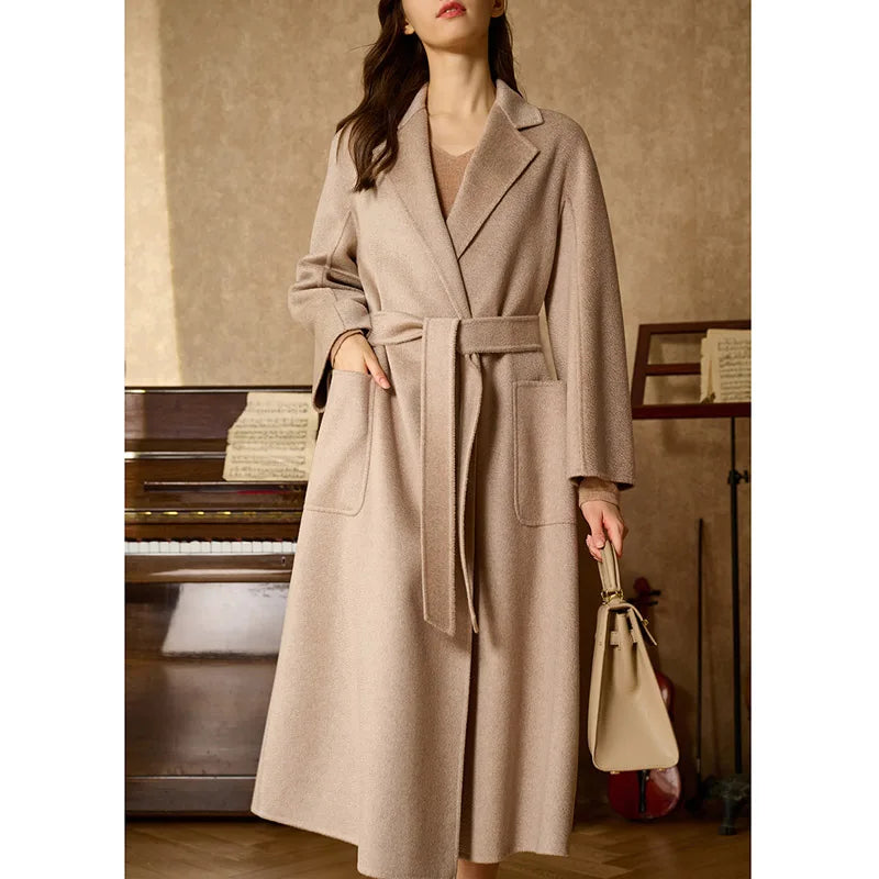 Women's Double-sided cashmere wrap coat in Sandrift with notched lapels and patch pockets, secured with a matching belt. From Borcelleclothes.