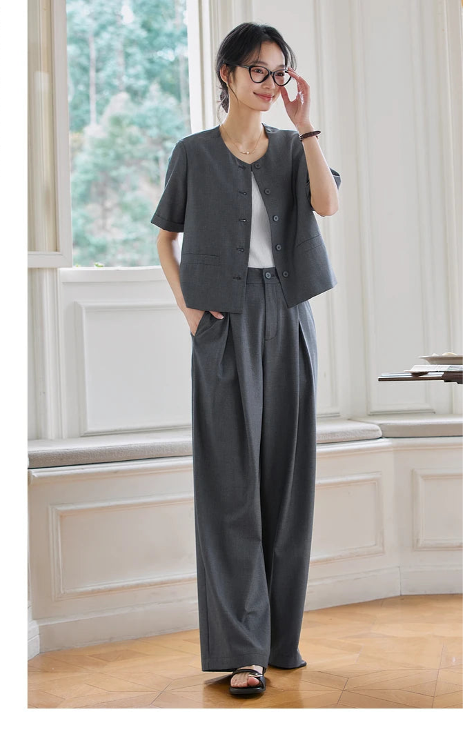Model adjusting her glasses while wearing the Fiord two-piece set. From Borcelleclothes.