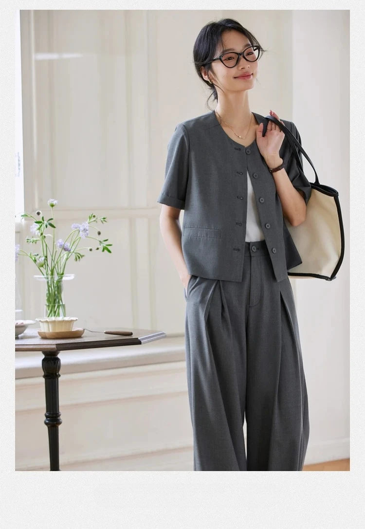 Model wearing the Fiord two-piece set with an oversized bag over her shoulders. From Borcelleclothes.