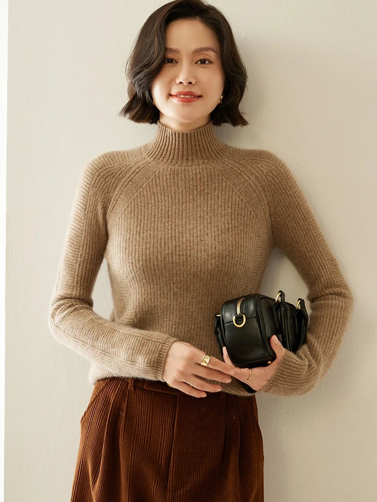 Model wearing Coffee With Cream cashmere sweater, holding a bag with one hand, showcasing the soft melange rib texture — From Borcelleclothes.