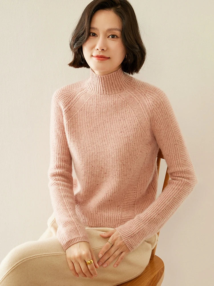 Model seated in Delicate Bloom sweater, soft folds emphasizing rib texture and relaxed shape — From Borcelleclothes.