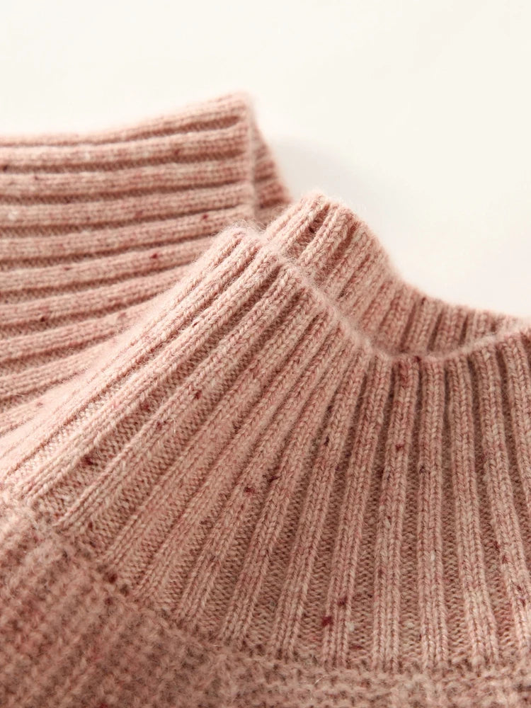 Delicate Bloom sweater mock neck shown with slight fold, revealing flexibility of rib structure — From Borcelleclothes.