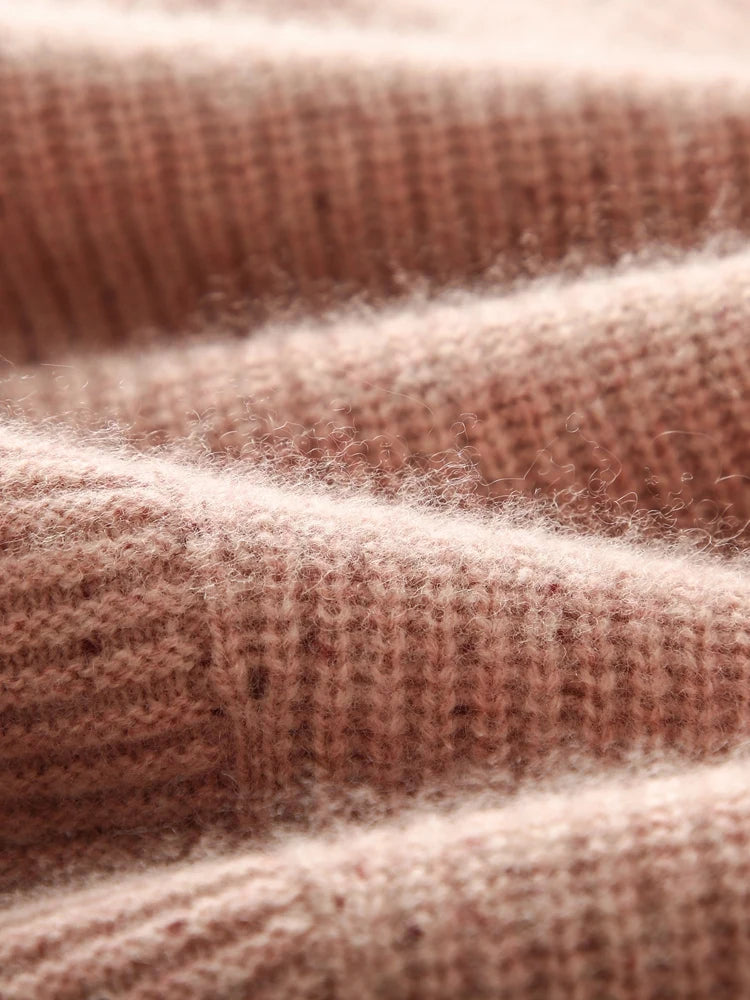 Wave-folded Delicate Bloom sweater showing diagonal purl stripe and sculptural rib surface — From Borcelleclothes.