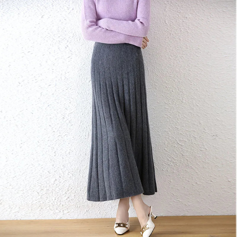 Women's flared pleat wool skirt in Davy Grey, model with crossed arms and legs — From Borcelleclothes.