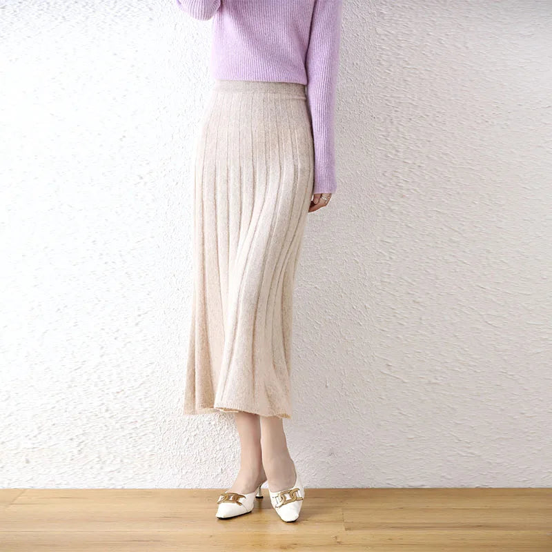 Women's flared pleat wool skirt in White Chocolate, model with bent leg — From Borcelleclothes.