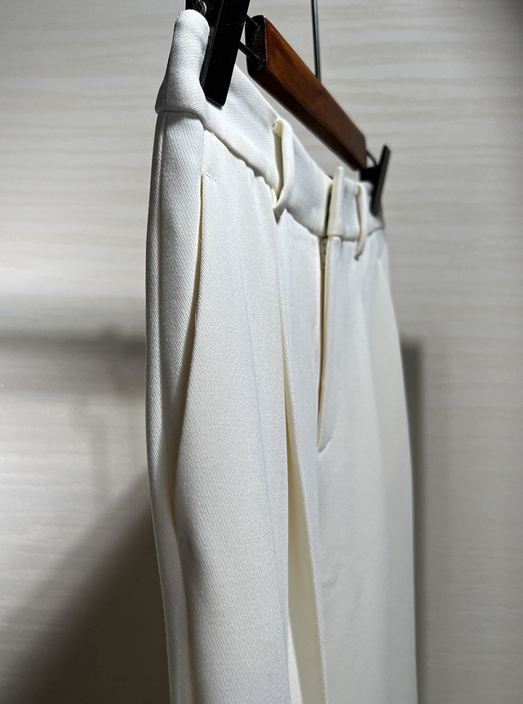 Upper section of Platinum trousers on hanger, emphasizing the tailored waistband and front tucks. From Borcelleclothes.
