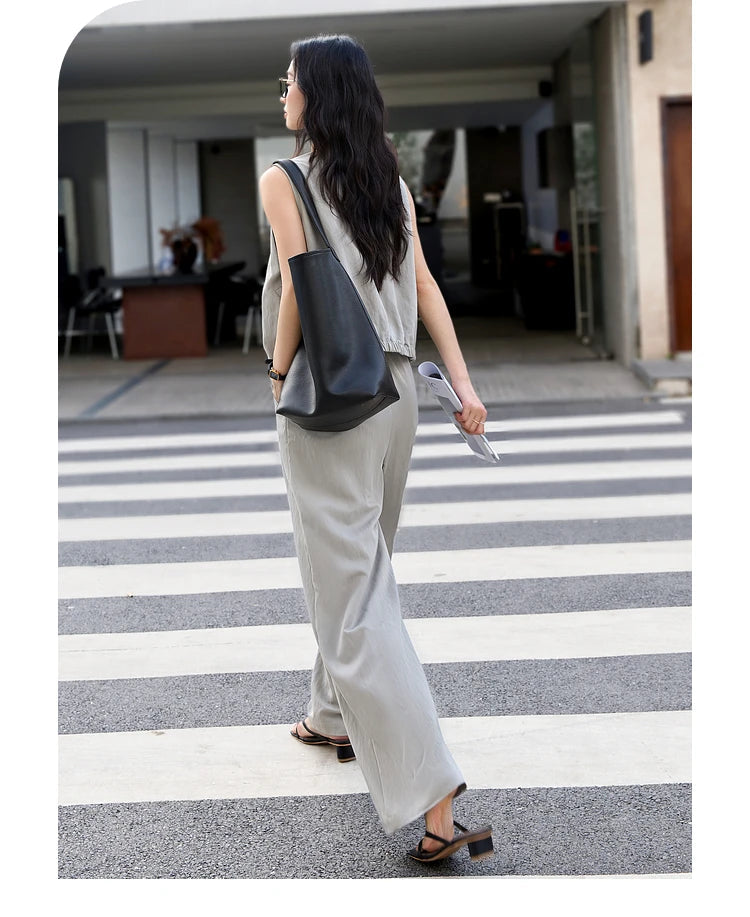 Rear view of the woman in the French Grey set, highlighting the back design of the jacket and trousers. From Borcelleclothes.