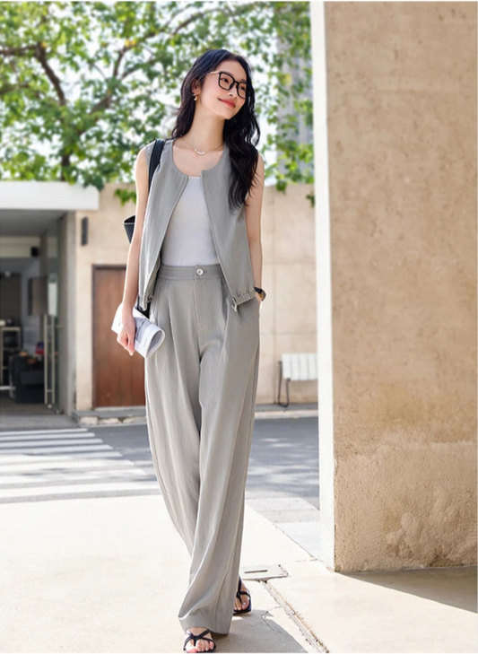 Women's French Grey two-piece set featuring a sleeveless zip-front jacket and softly structured twill trousers — an understated city ensemble in a breathable, denim-inspired fabric. From Borcelleclothes.