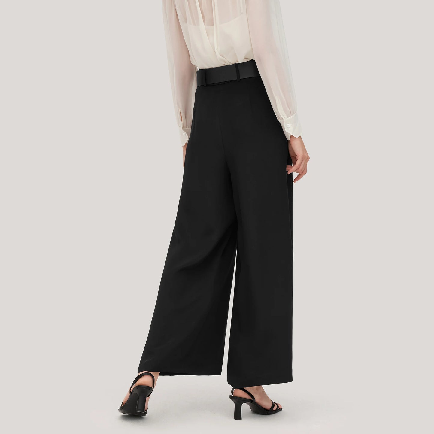 Back view of Onyx silk trousers in heavy crepe, highlighting the tailored waistband and the graceful weight of the fabric. From Borcelleclothes.