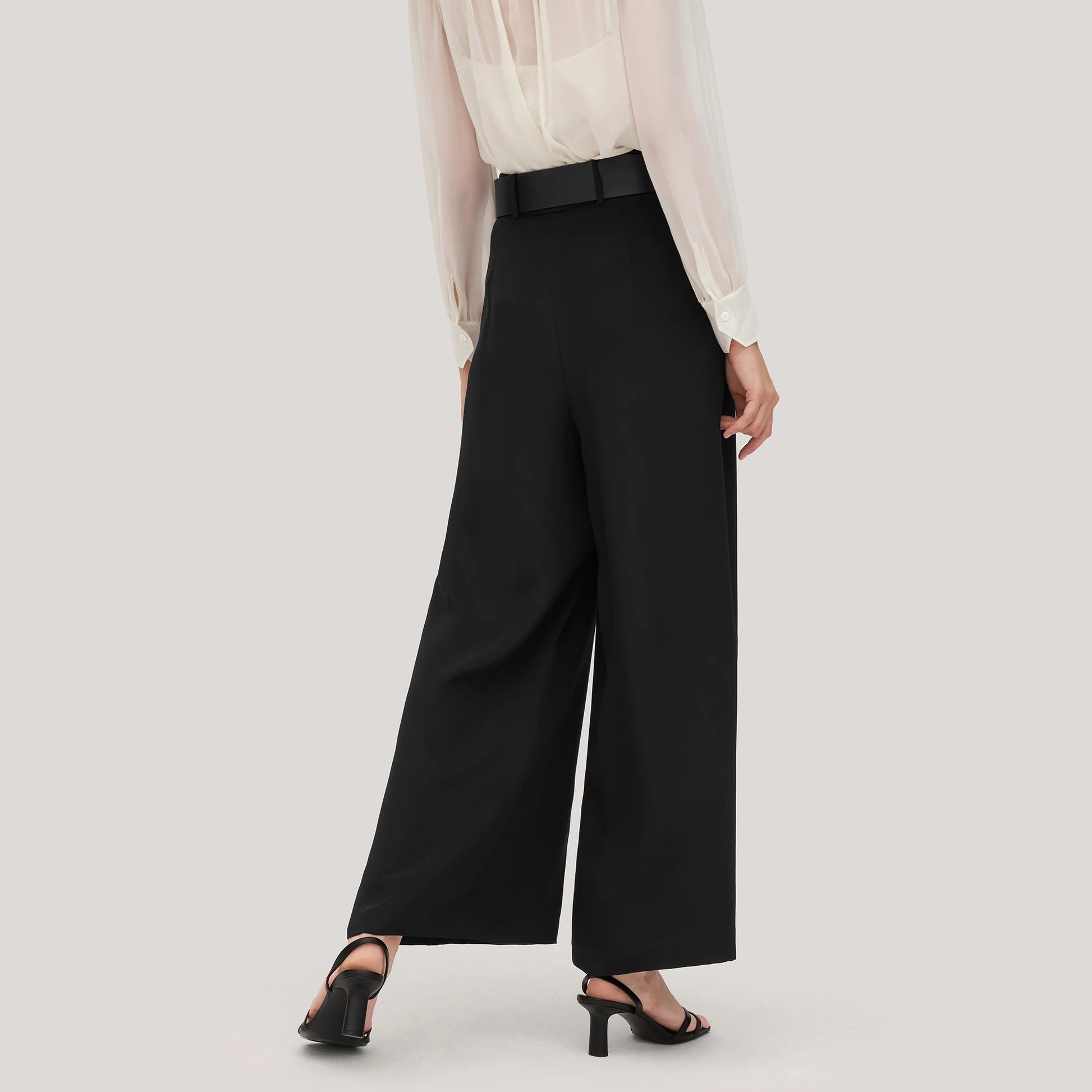 Back view of Onyx silk trousers in heavy crepe, highlighting the tailored waistband and the graceful weight of the fabric. From Borcelleclothes.