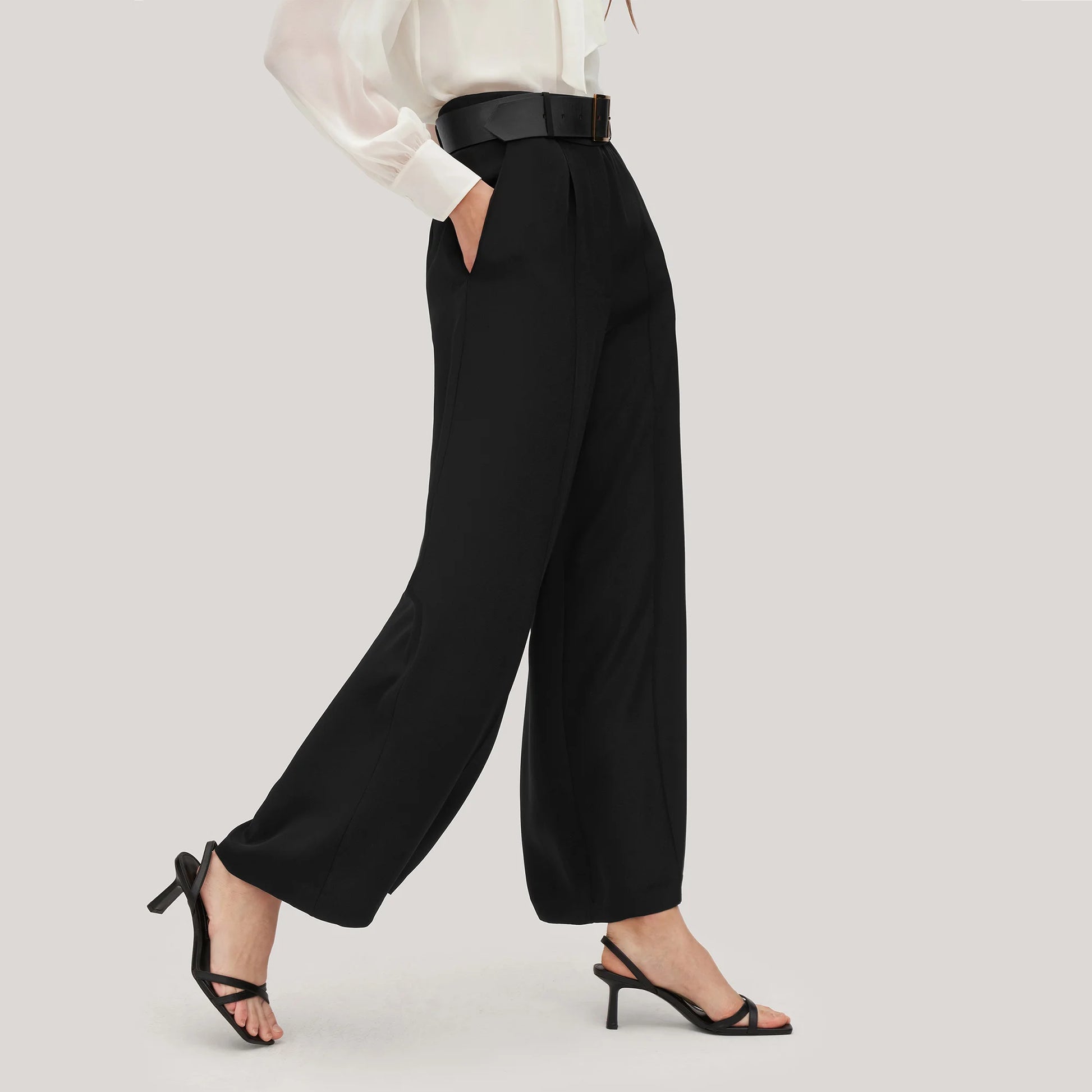 Side view of women's wide-leg silk trousers in Onyx, showing the fluid fall and defined structure of heavy crepe. From Borcelleclothes.