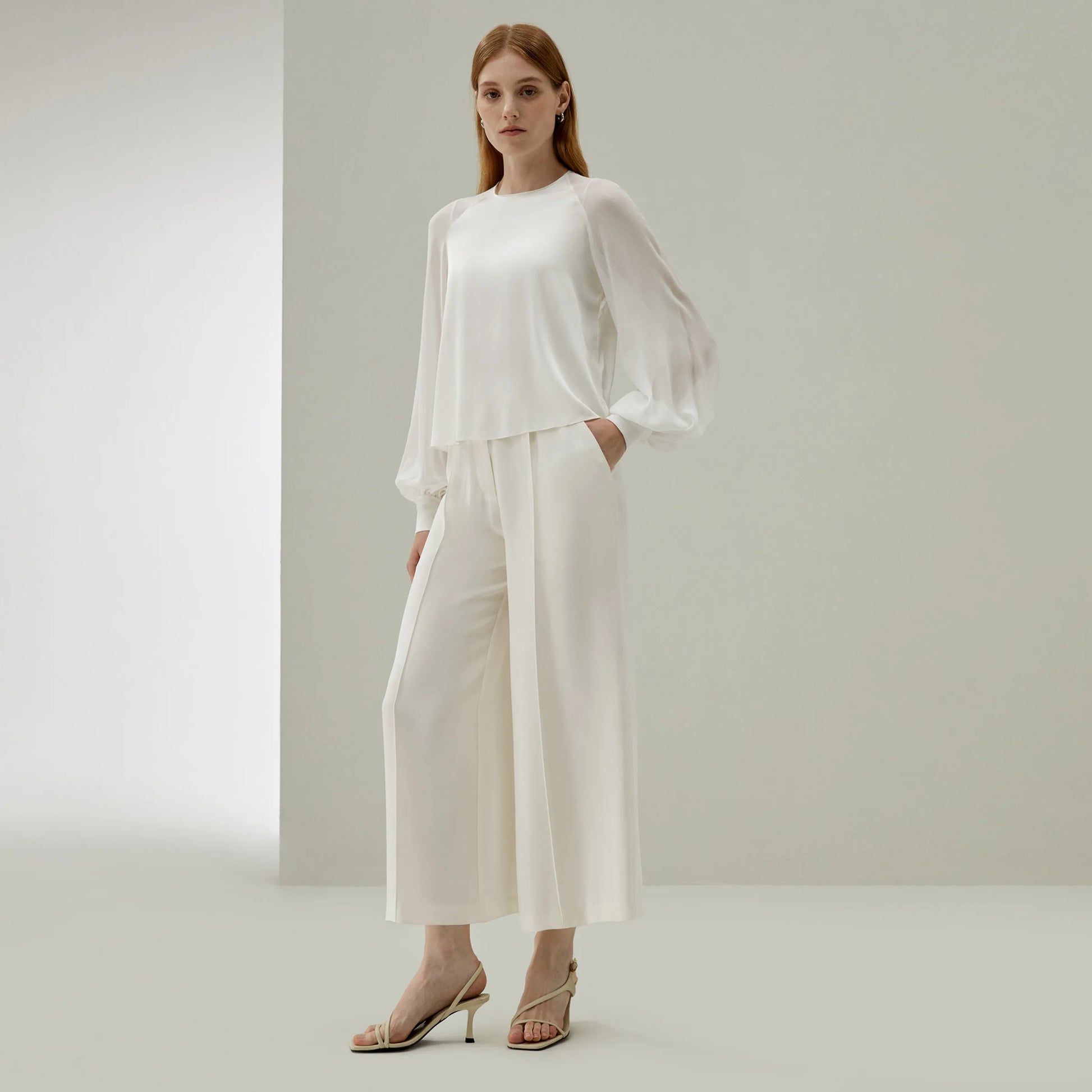 Model wearing Pearl Bush silk trousers in heavy crepe, one leg slightly bent, revealing the fabric’s generous drape and soft tension. From   Borcelleclothes.