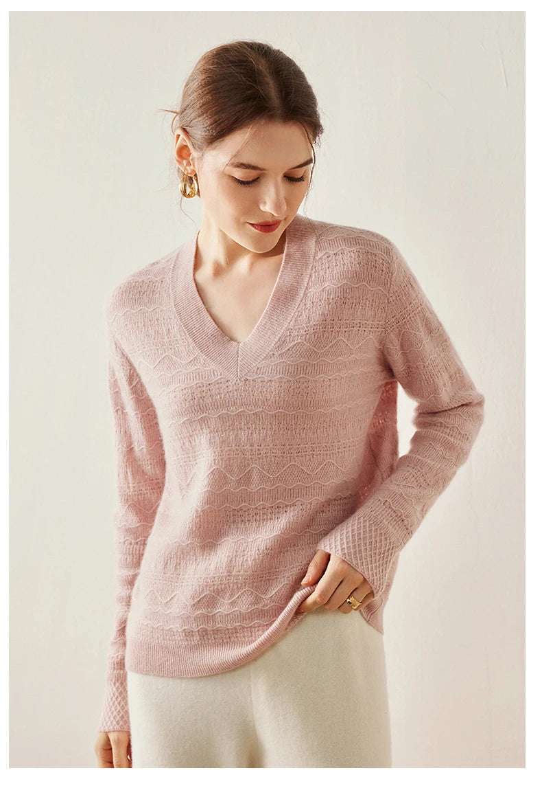 Himalayan cashmere sweater in French Romance with model lifting bottom hem slightly — From Borcelleclothes.