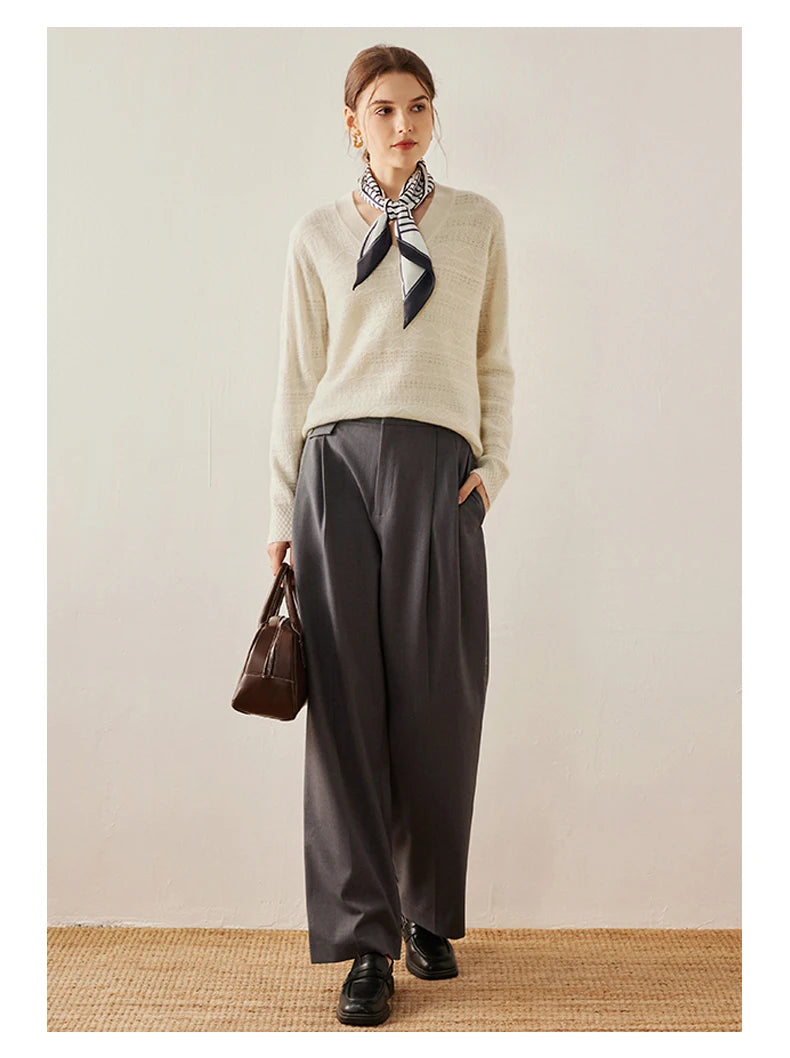 Himalayan cashmere sweater in Pearl Bush with model holding a bag — From Borcelleclothes