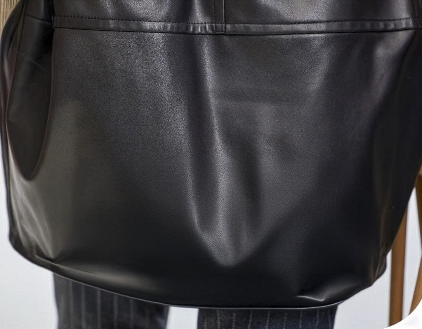 Bottom hem detail of the Onyx sheepskin coat, showing the subtle curve and unbroken back line. — From Borcelleclothes.