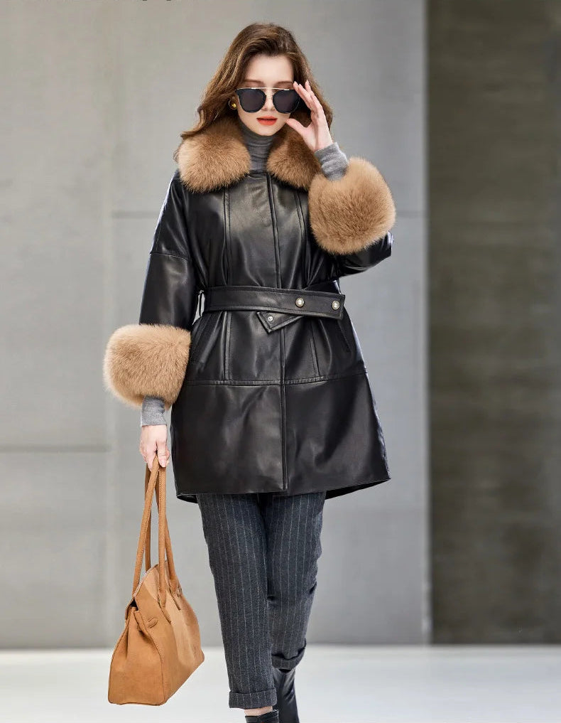 Model in Onyx sheepskin coat adjusting sunglasses, highlighting the clean collar line and kimono sleeve. — From Borcelleclothes.