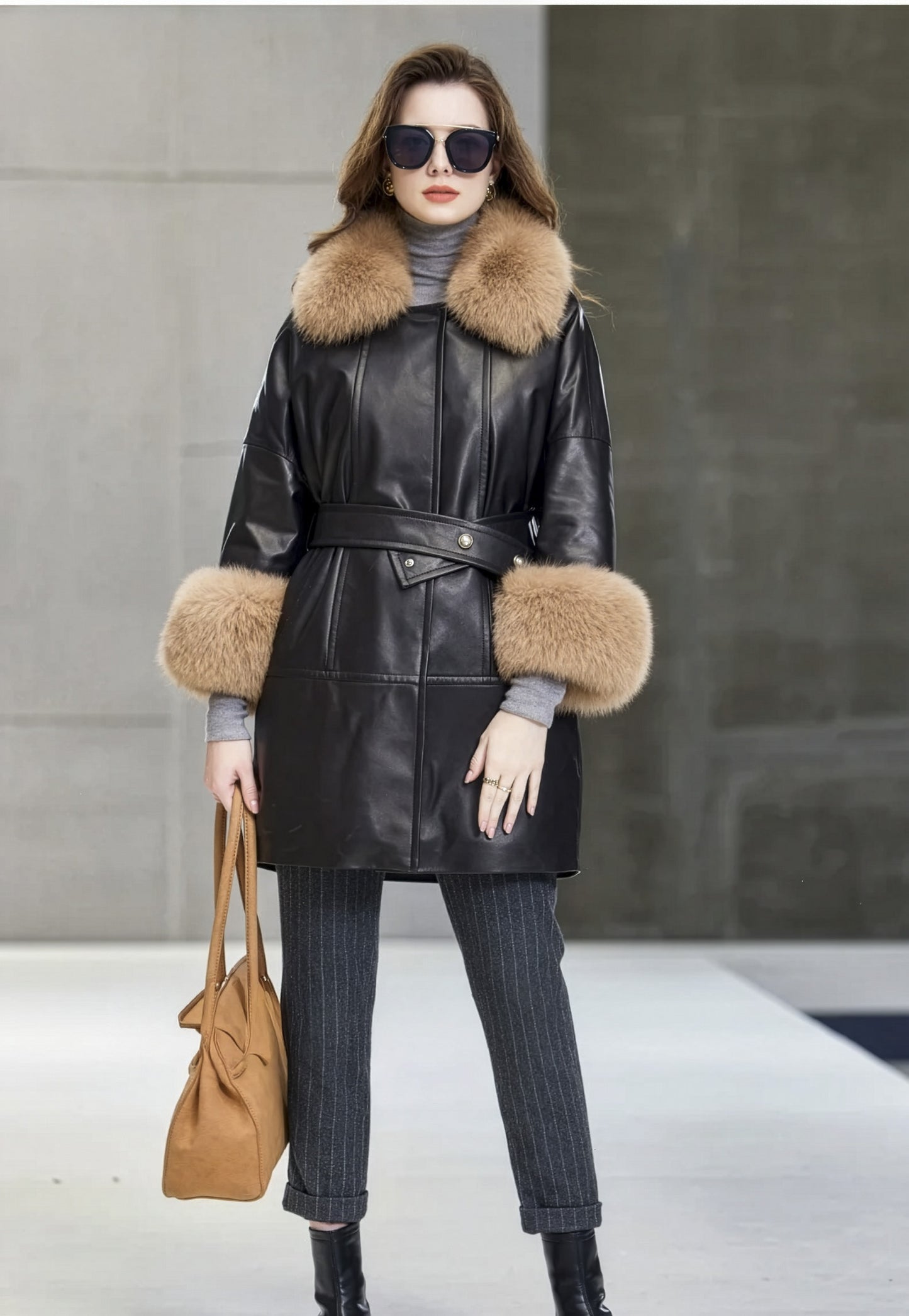 Model in Onyx sheepskin coat holding a brown bag, accentuating the neutral harmony of the ensemble. — From Borcelleclothes.