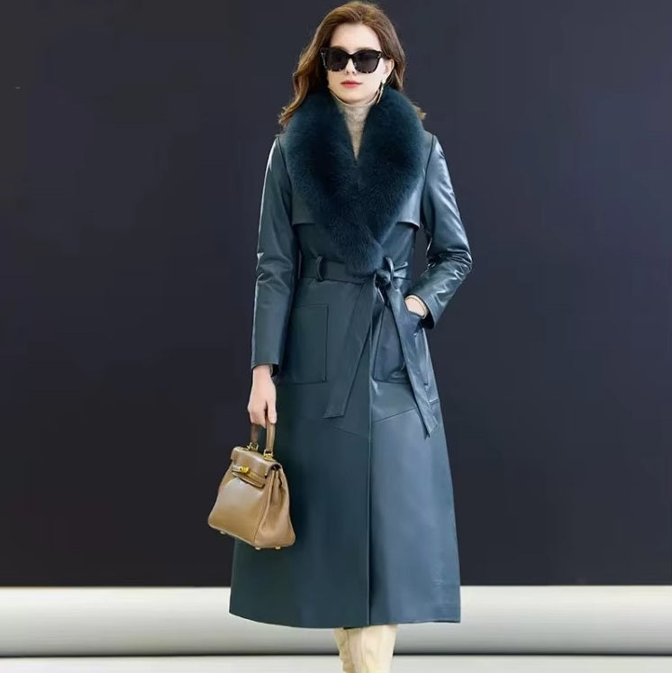Women's Leather Coat of Prestige in Nile Blue. Model rests a hand in the patch pocket, showcasing the thoughtful placement and seamless integration into the wrap-style design. Borcelleclothes.