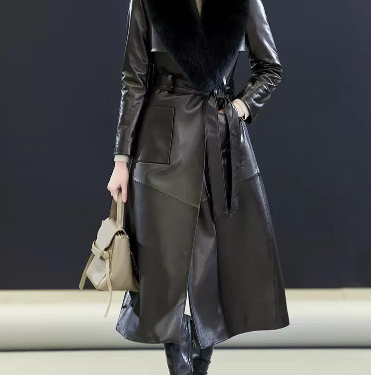 Women's Leather Coat of Prestige in Onyx. Model places a hand in the pocket, accentuating the coat’s functional refinement and structured leather drape. Borcelleclothes.