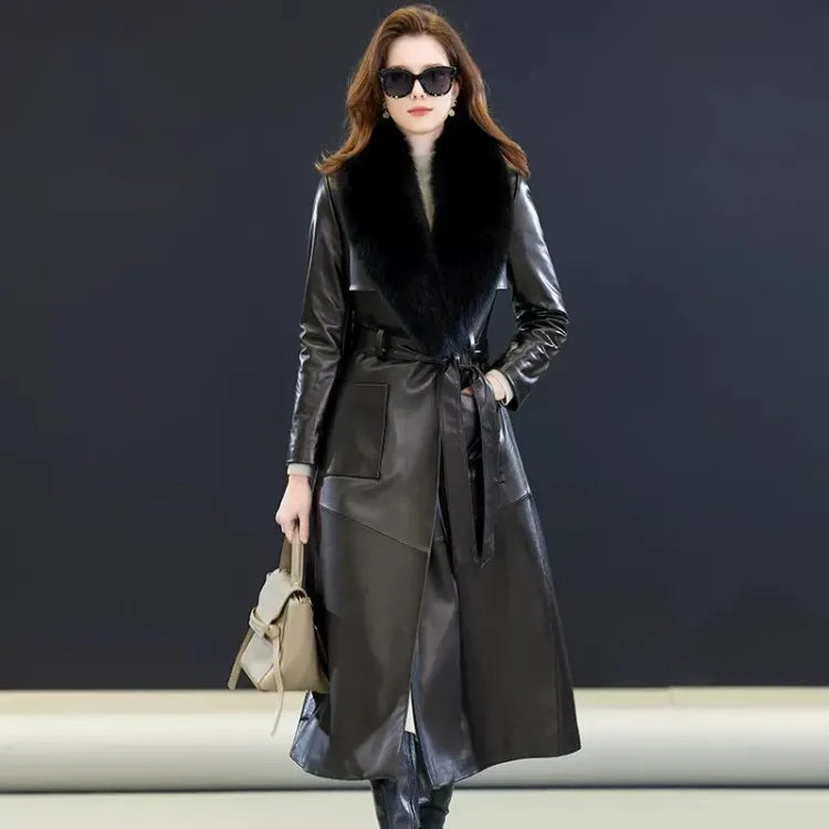 Women's Leather Coat of Prestige in Onyx. A mid-calf wrap coat crafted from sumptuous sheepskin, designed for effortless elegance and quiet confidence. Featuring a structured yet fluid silhouette, notch lapels, a detachable fox fur collar, and refined patch pockets. A statement of poise and authority. Borcelleclothes.