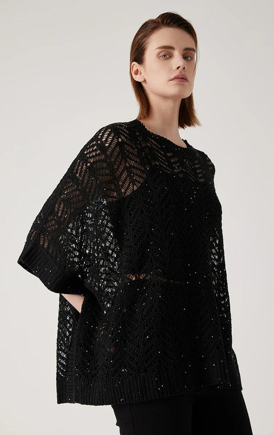 Side view of Onyx linen poncho, openwork lace hovering gently around the body in suspended form. From Borcelleclothes.