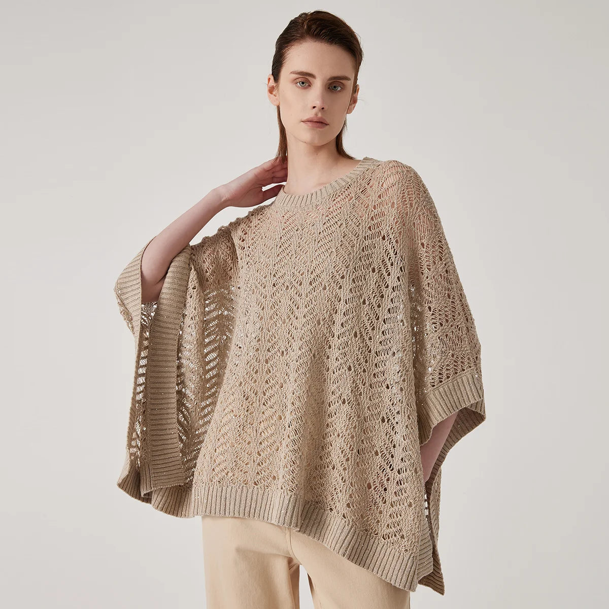 Women's linen lace poncho in Vanilla - in an airy rectangular cut with abstract openwork knit and underarm tacking for sculpted drape. From Borcelleclothes.