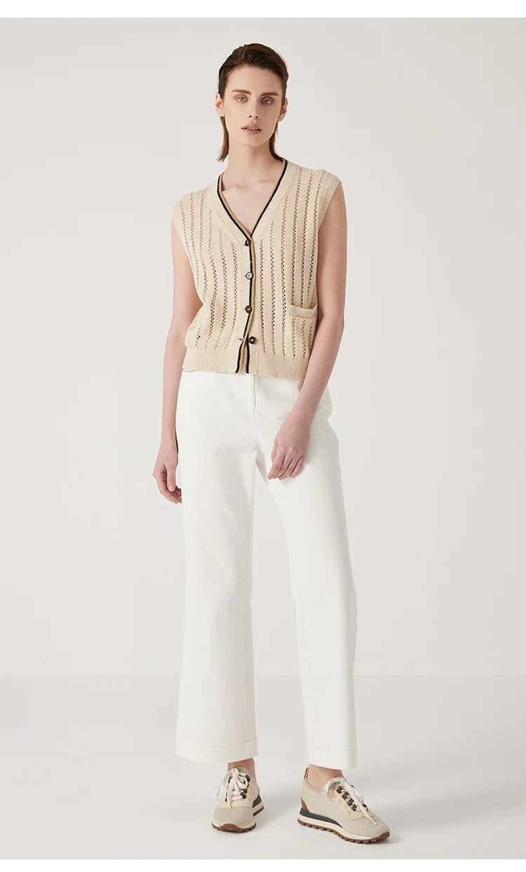 Full-length view of Almond linen lace vest, minimalist composition of openwork, contrast stripes, and a singular pocket. From Borcelleclothes.