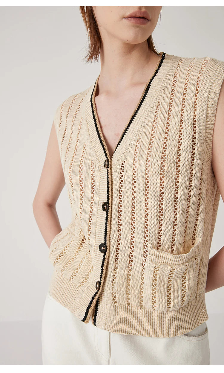 Model in Almond linen lace vest with hands behind, exposing armhole cut and fluid rhythm of the vertical lace design. From Borcelleclothes.