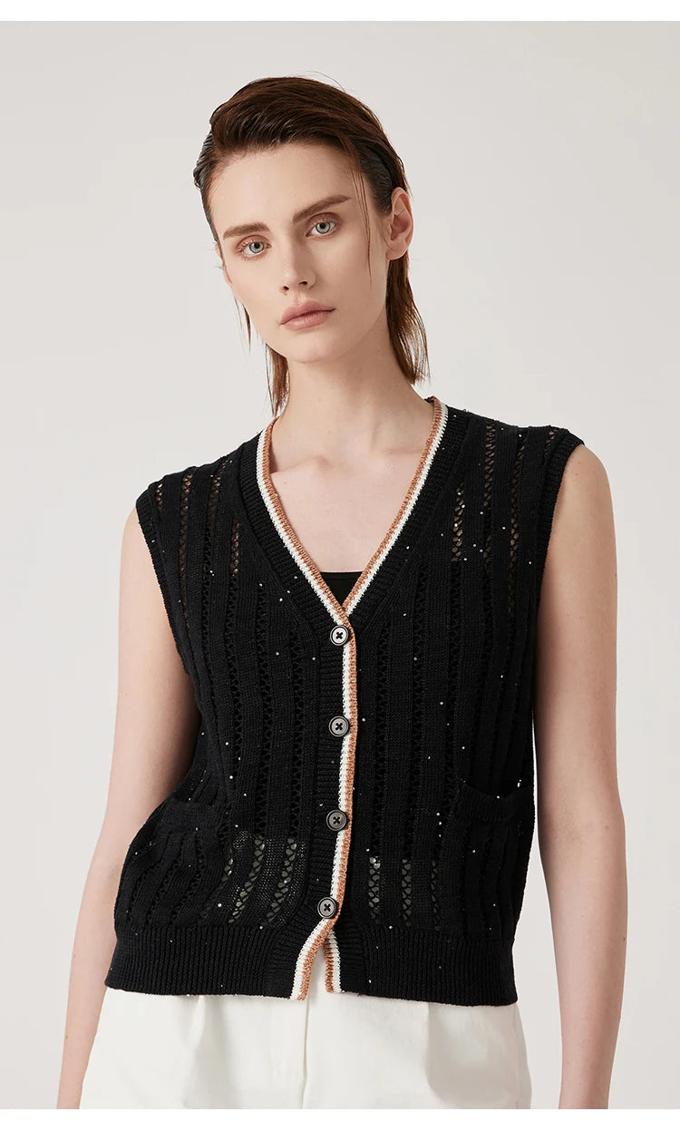 Woman in black linen lace vest standing with arms straight, showing vertical openwork stripes and contrast rib trim. From Borcelleclothes.