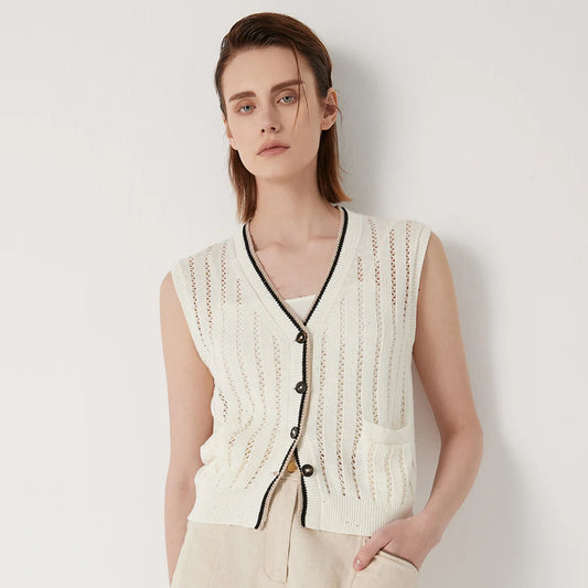 Women's linen lace vest in Pearl Bush with vertical stockinette and lace stripes, contrast ribbed trim, and a single patch pocket—minimal, structured, and quietly striking. From Borcelleclothes.