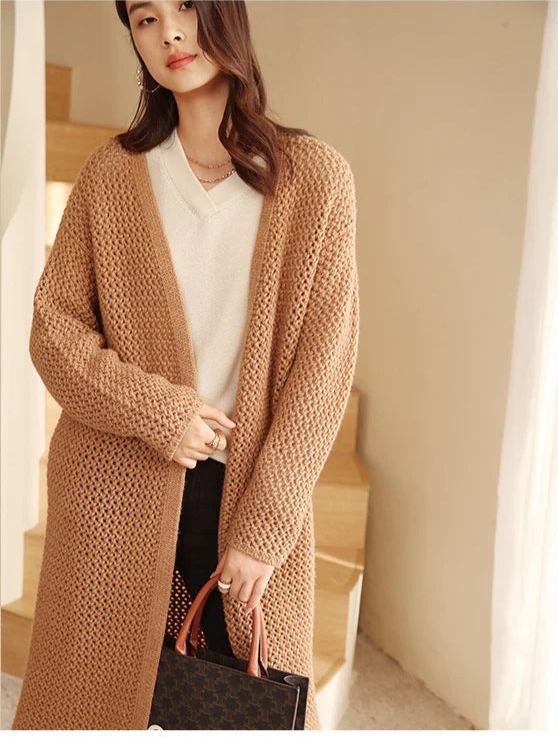 Model holding the front edge of the Fox-color cardigan — From Borcelleclothes.