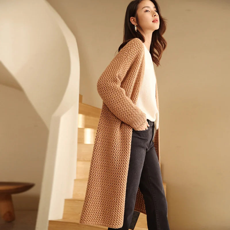 Model wearing the long mesh cashmere cardigan in Fox-color, shown from the side — From Borcelleclothes.