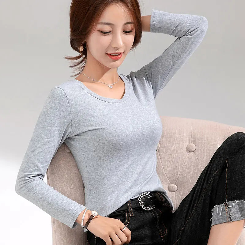 Women's Long-Sleeve Scoop Neck T-Shirt in French Grey, featuring a soft and stretchy cotton blend for a comfortable, figure-enhancing fit. This versatile top offers a casual yet elegant look with its graceful scoop neck and solid pattern, perfect for layering or wearing on its own. From Borcelleclothes.
