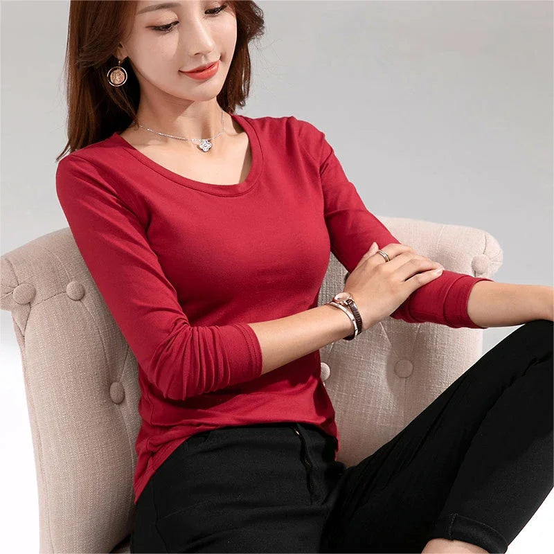 Women's Long-Sleeve Scoop Neck T-Shirt in Jasper, featuring a soft and stretchy cotton blend for a comfortable, figure-enhancing fit. This versatile top offers a casual yet elegant look with its graceful scoop neck and solid pattern, perfect for layering or wearing on its own. From Borcelleclothes.