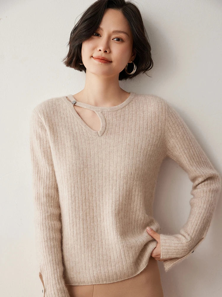 Loop neckline cashmere sweater in Dark Vanilla with model holding bottom hem — From Borcelleclothes.