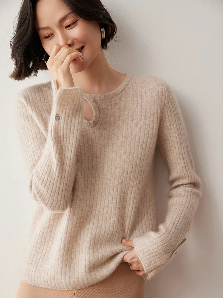Loop neckline cashmere sweater in Dark Vanilla with model touching nose — From Borcelleclothes.