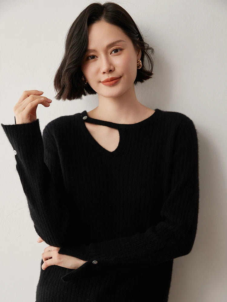 Loop neckline cashmere sweater in Onyx with model raising one arm — From Borcelleclothes.