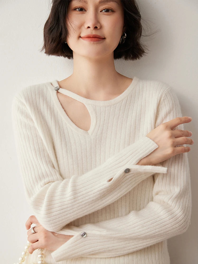 Loop neckline cashmere sweater in Pearl Bush with model’s arms gently folded across — From Borcelleclothes.