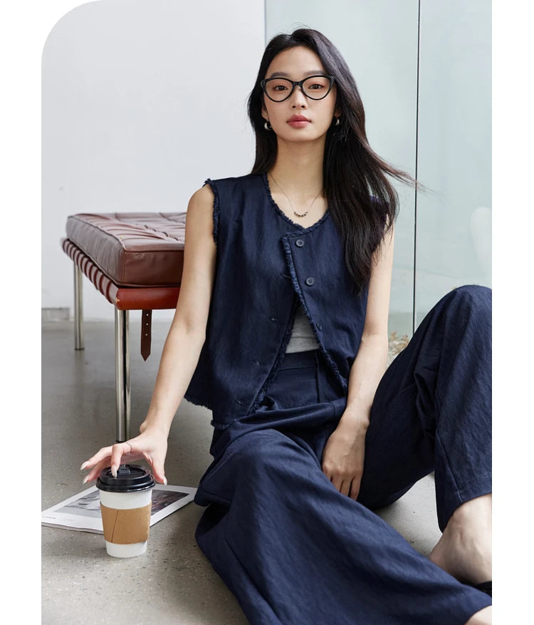 Model sitting on the floor with a cup of coffee in the Lucky Point set. From Borcelleclothes.