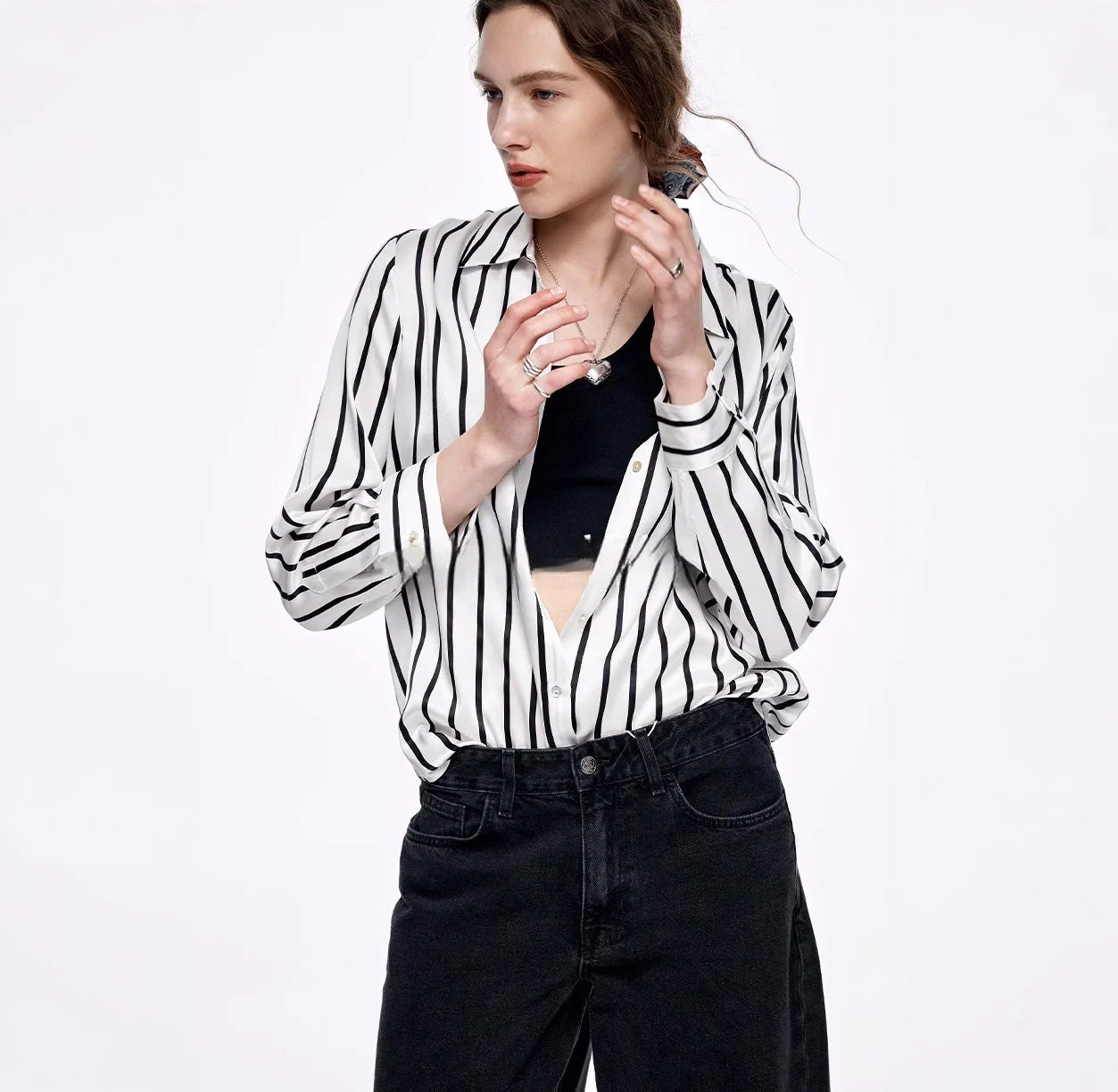 Model wearing the unbuttoned Women's Luxury 6A Mulberry Silk Shirt in He Loves Me, raising her arms to highlight the comfortable and relaxed design. From Borcelleclothes.
