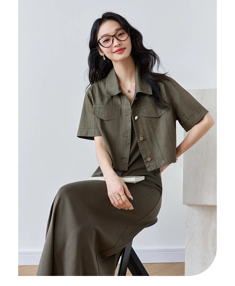 Model sitting on a chair in the Makara outfit, emphasizing the knit dress's comfort in a seated pose. From Borcelleclothes.
