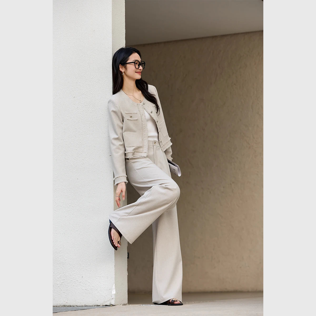 Model leaning casually against a wall in the Martini set, projecting an effortless elegance. From Borcelleclothes.
