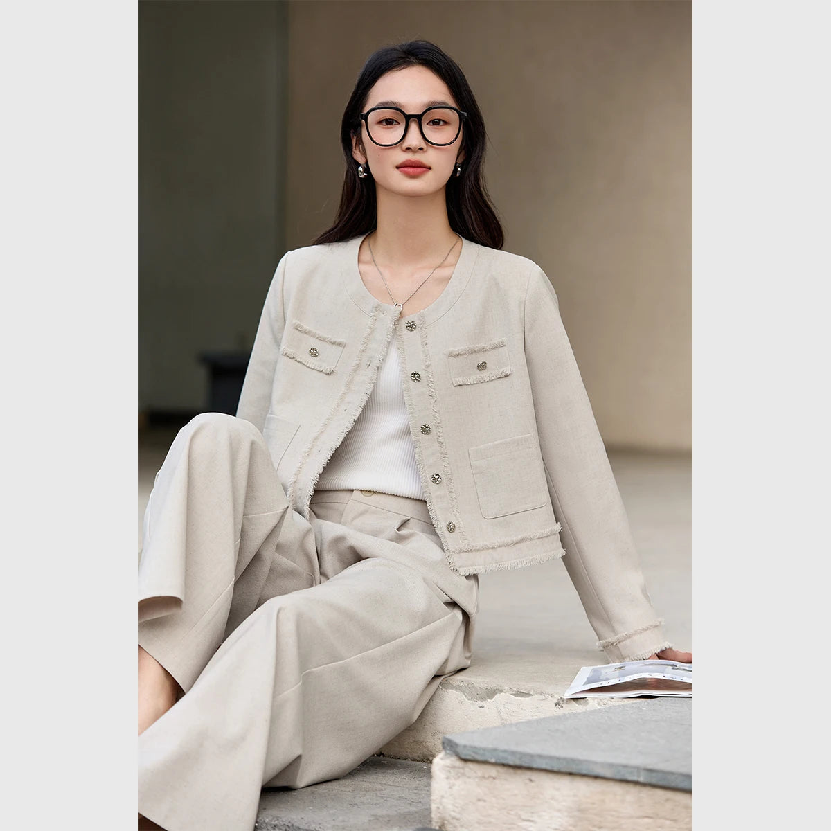 Model sitting on outdoor steps in the Martini set with a relaxed, open posture. From Borcelleclothes.