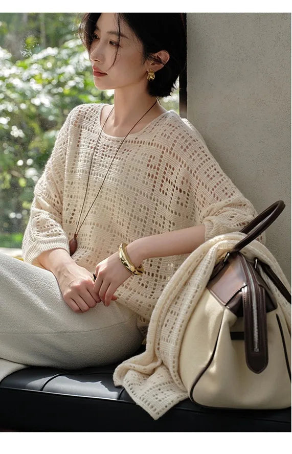 Model looking to the side while seated in the Meander cashmere top – From Borcelleclothes.