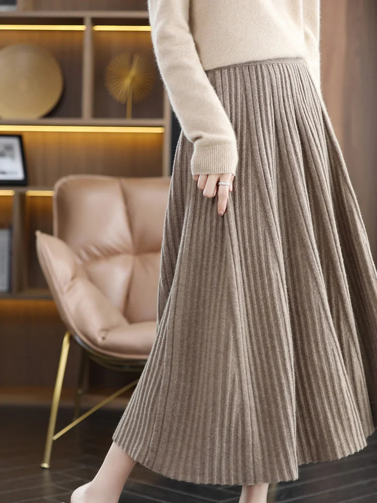 Model wearing merino skirt with textured pleats in Almond Frost, turned slightly to the left — From Borcelleclothes.