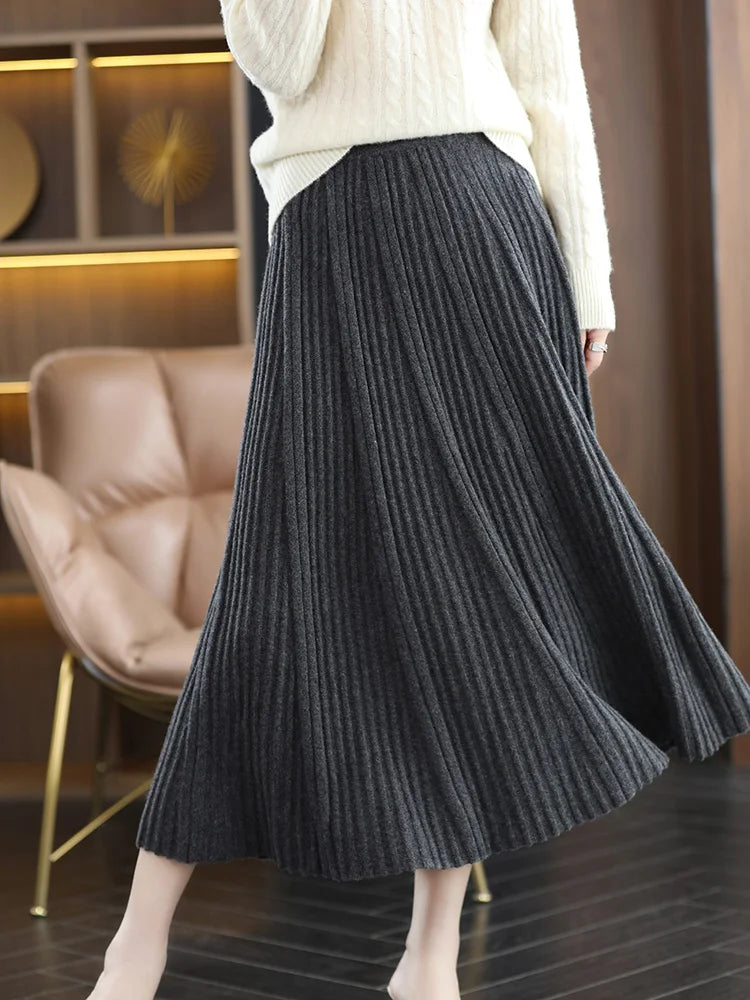 Model wearing merino skirt with textured pleats in Davy Grey, captured in motion — From Borcelleclothes.