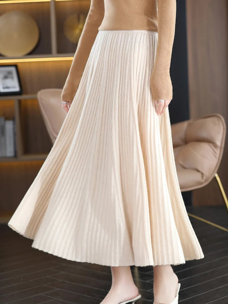 Model wearing merino skirt with textured pleats in Pearl Bush, turned slightly to the right — From Borcelleclothes.