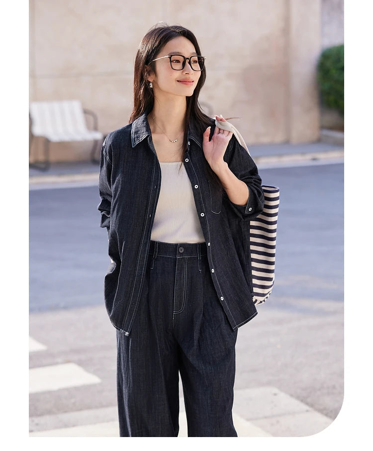 Woman holding a bag over shoulder — Midnight Express shirt and trousers styled in casual, confident form. From Borcelleclothes